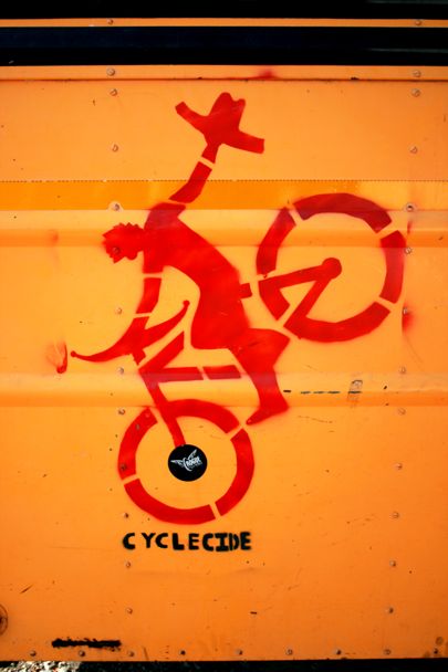 Cyclecide stencil on the outside of their bus
